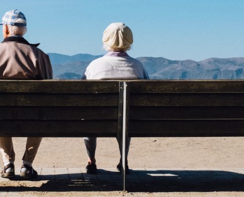 seniors on a bench, assisted living vs memory care