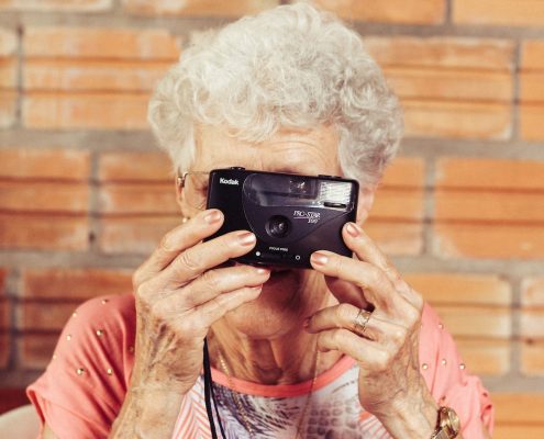 assisted living community, elderly woman taking a picture
