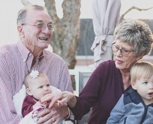 what is independent living, grandparents holding baby and small child